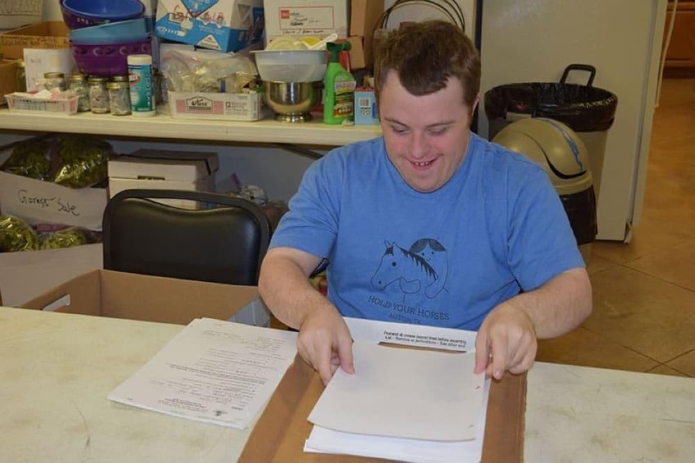 A New Caney New Horizons patron organizes paper work while assisting at the nonprofit's resale shop. (Courtesy New Caney New Horizons)