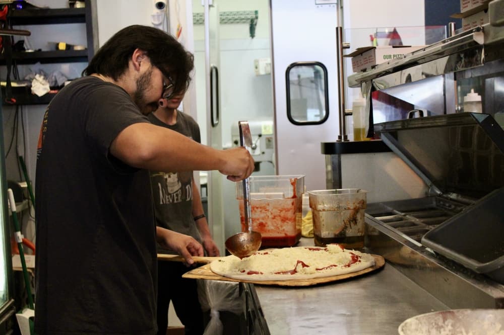 Owner making pizza 
