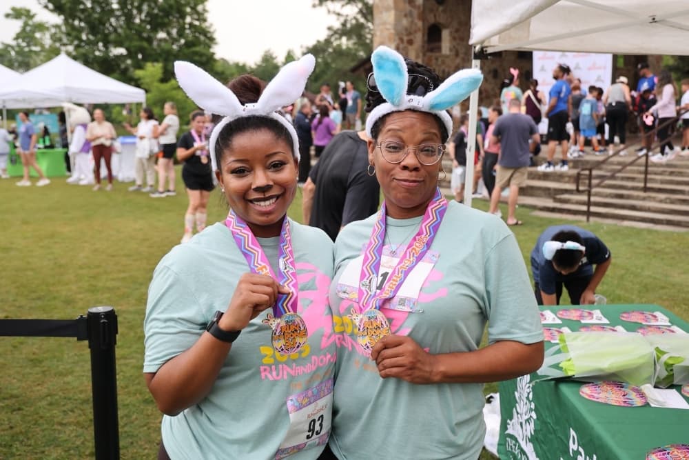 women in bunny ears show off medals
