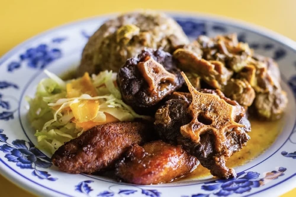 Tony Scott created the combination plate on the menu so customers didn’t have to choose between their favorite meats. For first time customers, he recommends people try the jerk chicken and oxtail ($25). (Katlynn Fox/Community Impact)