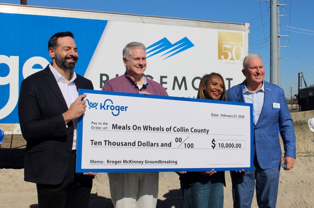 Kroger officials and Meals on Wheels officials pose with a check during the event. 
