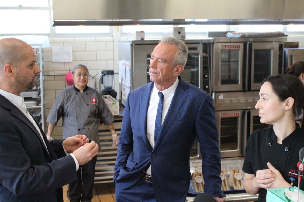 U.S. Secretary of Health and Human Services Robert F. Kennedy Jr. speaks with Austin ISD staff in the elementary school cafeteria kitchen.