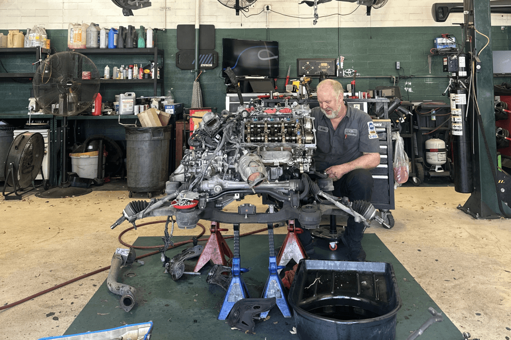 master certified technician working on car parts