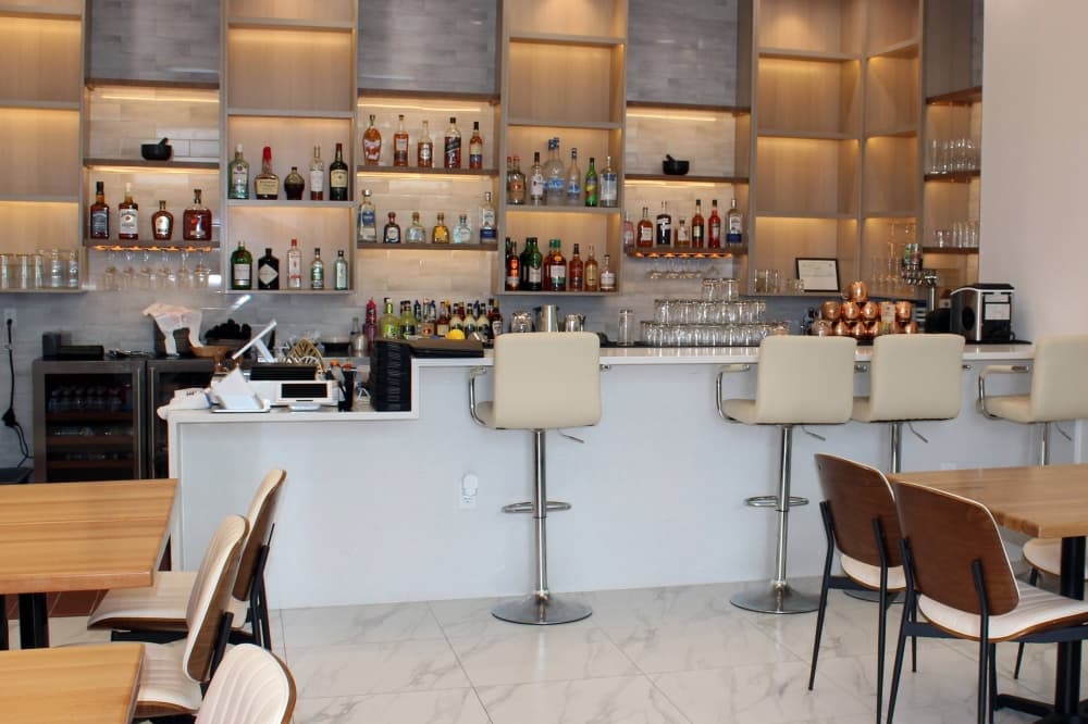 Interior of a dining area featuring a bar. 