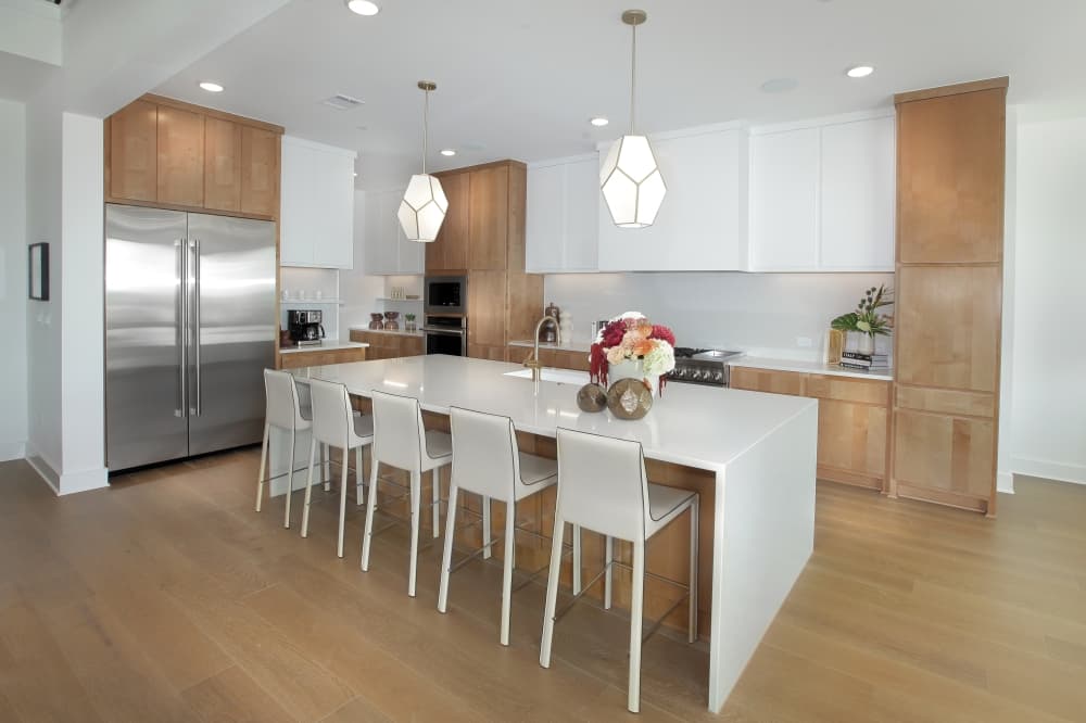 Modern open-concept kitchen and living area inside a Drees Custom Home in Hilltop Ranch Leander