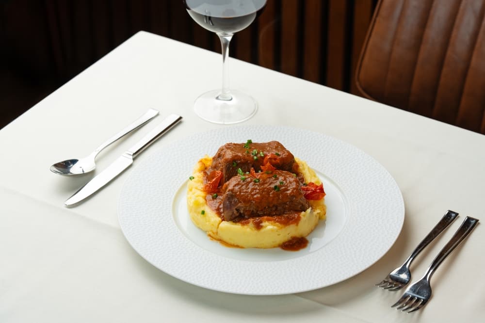 The Brasato al Barolo is made of slowly braised short ribs on soft polenta, or yellow cornmeal, with taleggio cheese. (Courtesy Acquario Italian Restaurant)