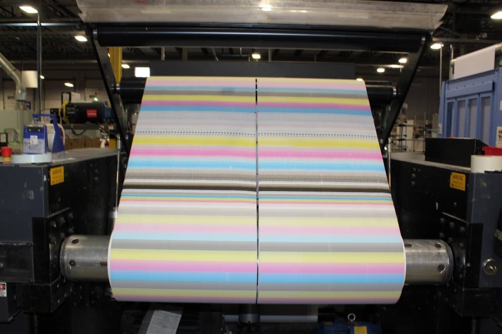 Printer paper with color testing running through a printer. 