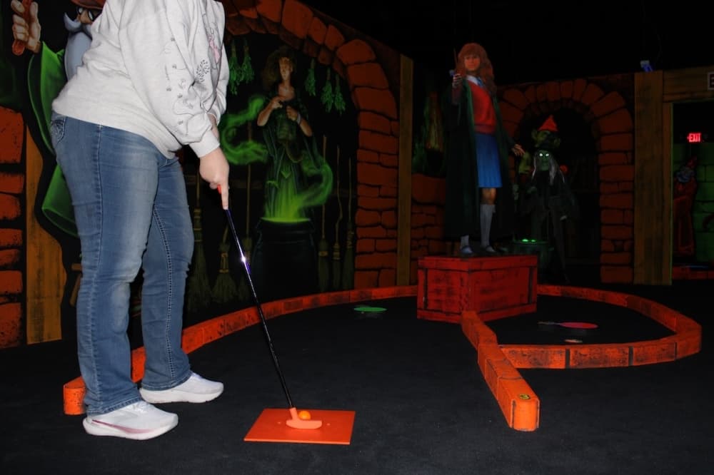 A players tees up to putt on the course.
