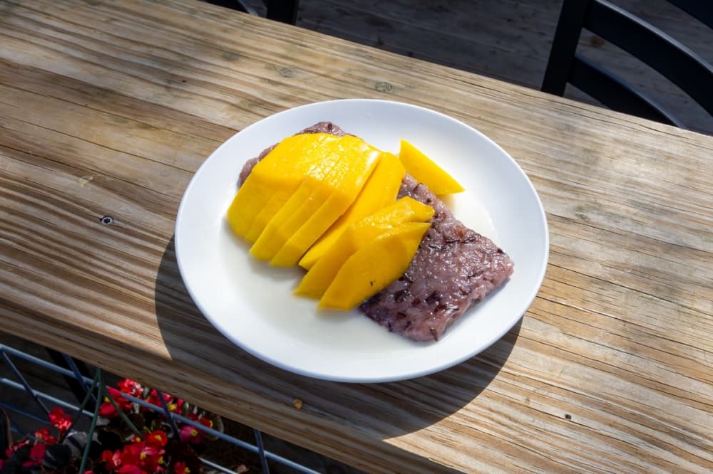 Mango Sticky Rice ($8) is a classic Thai dessert, with riceberry sticky rice, fresh Mango and sweet coconut sauce. (Ethan Thomas/Community Impact)