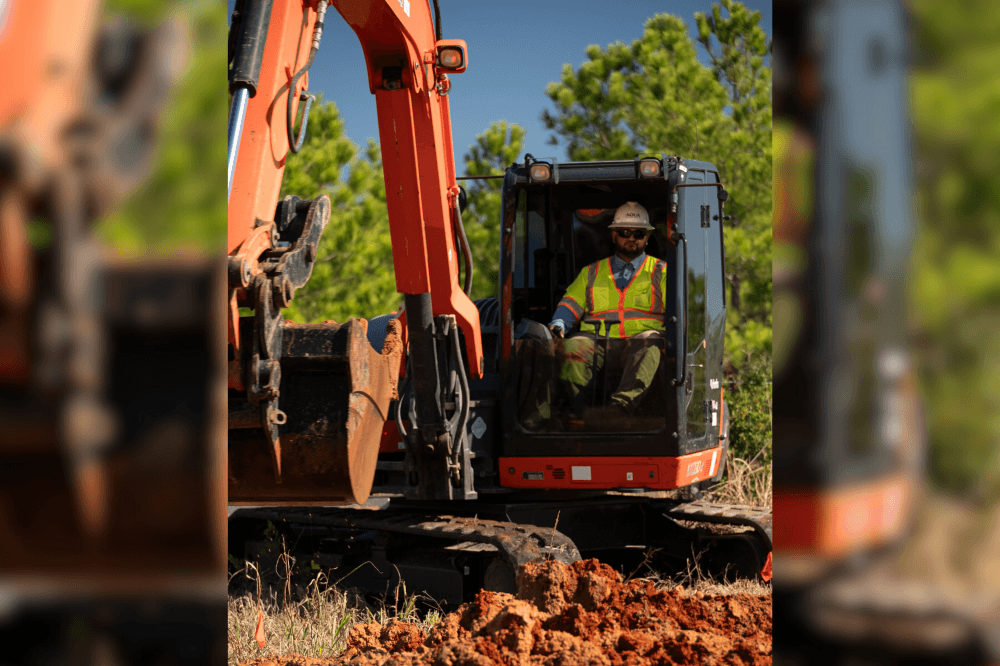 Aqua Water Supply employees digging with a crane