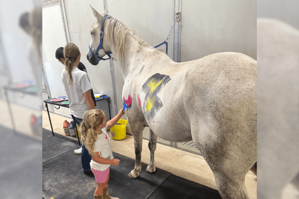 Children painting a horse