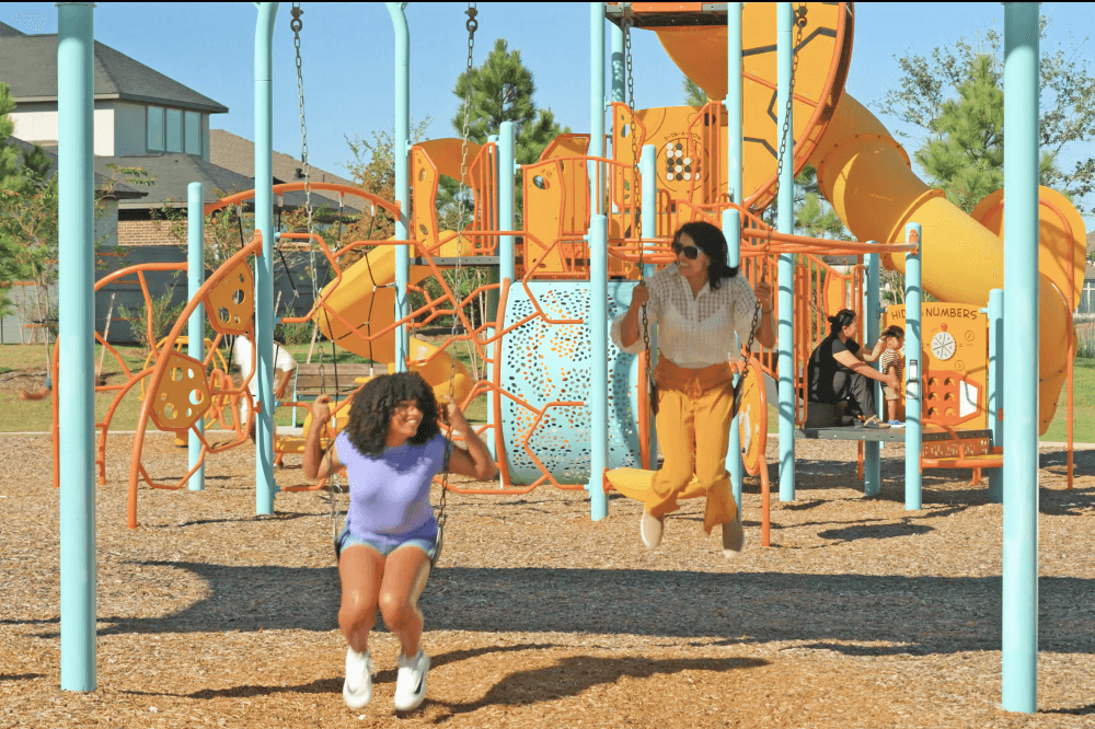 Families exploring parks and gathering spaces inside Jubilee master-planned wellness community in Hockley Texas.