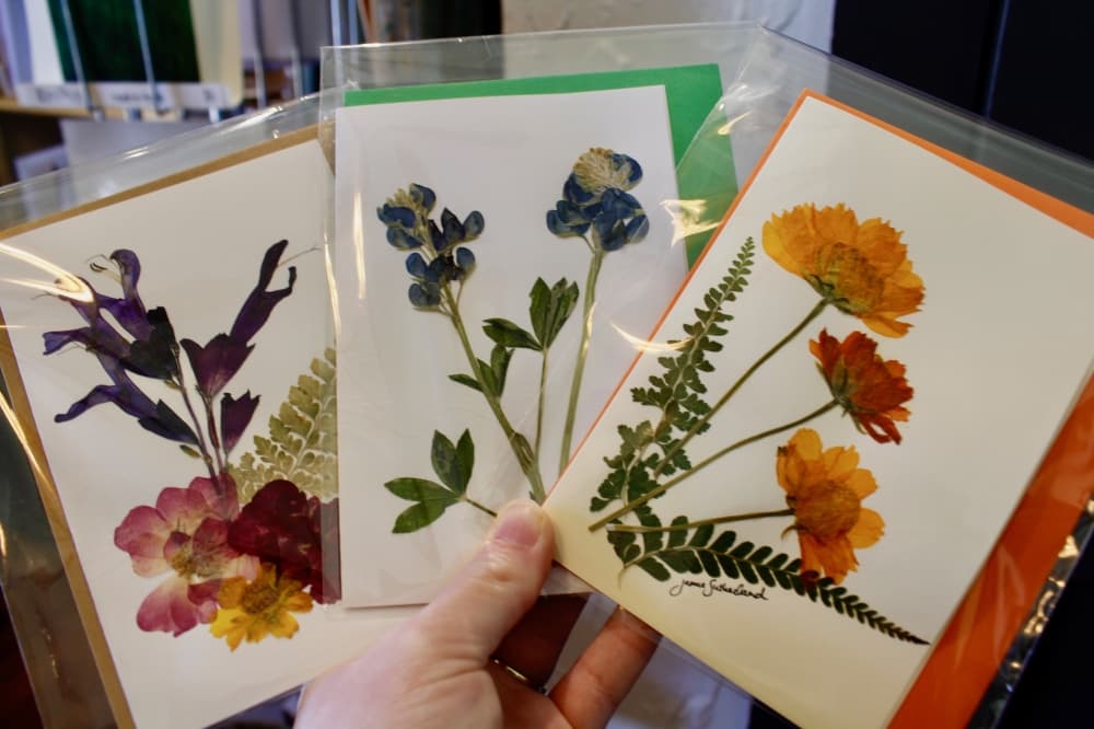 The shop sells locally grown flowers that are dropped off by Jamie Sutherland, and if they aren’t sold, Sutherland presses them into cards that shoppers can purchase. (Heather McCullough/Community Impact)