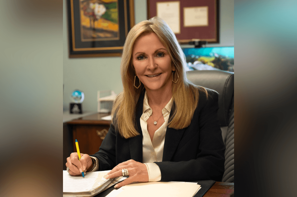 Stephanie Marquard, owner of The Original Kingwood Air Conditioning and Heating, standing with HVAC equipment and service tools in Kingwood, Texas, representing trusted local air conditioning repair, HVAC maintenance services, indoor air quality solutions and expert home cooling support for homeowners preparing for summer heat