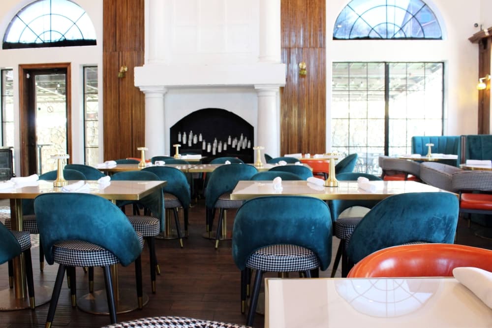 Interior of a restaurant featuring dark teal and orange design elements. 