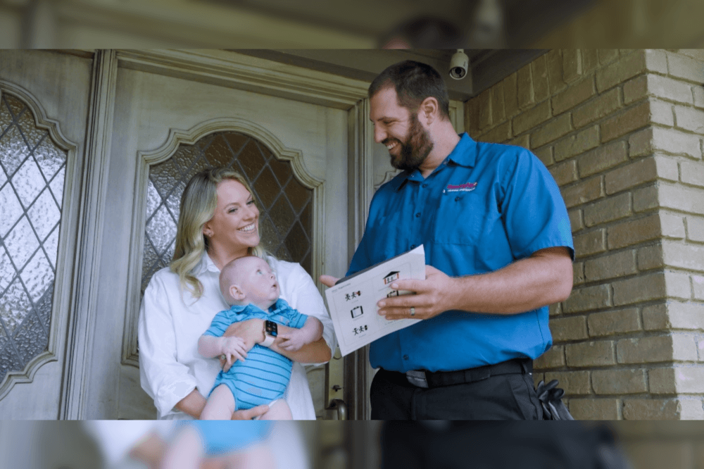 man talking to woman and baby