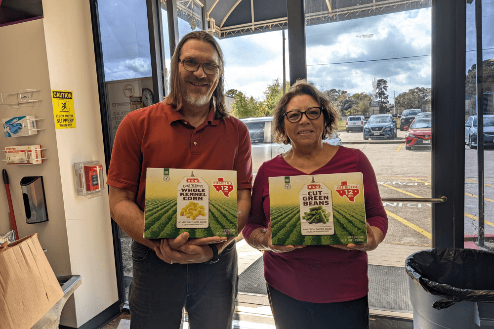 people holding iced tea boxes