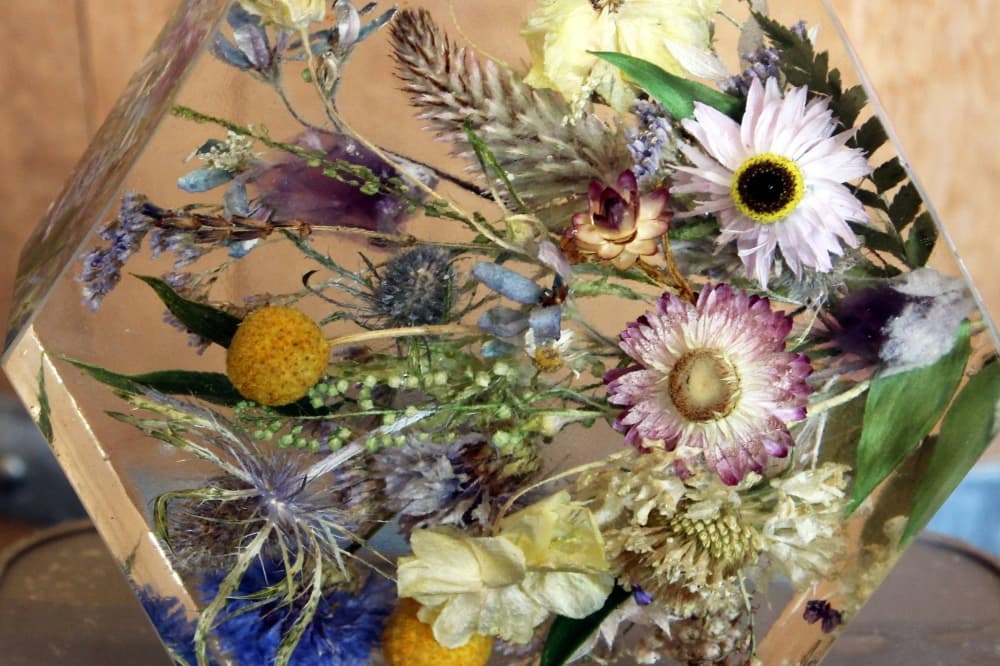 Dried flowers encased in an epoxy art sculpture. 