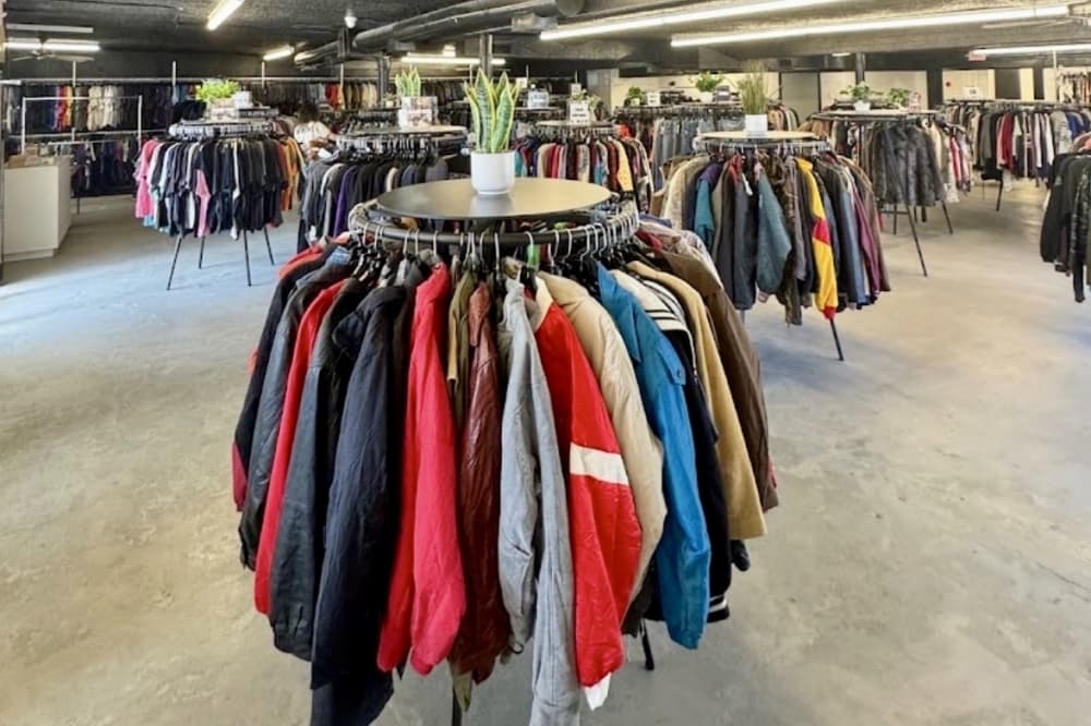 The inside of the store with racks of clothes 