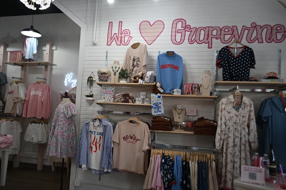 Clothing sits on a display within Grapevine's Grace Emma.