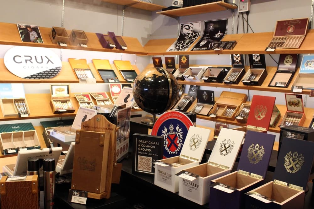 Cigar boxes and globe displayed in a retail humidor. 