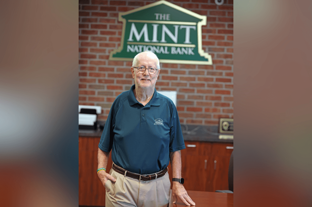 Interior of The MINT National Bank Kingwood branch with staff assisting customers and providing personalized service.