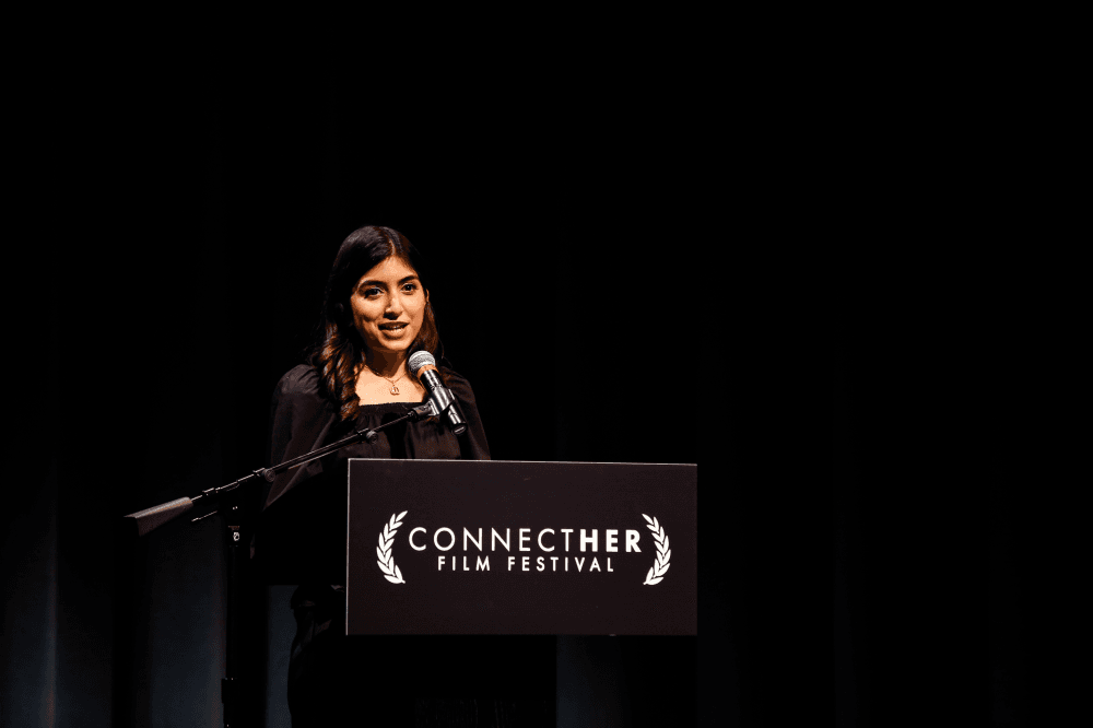 Halimah Tariq speaking on stage