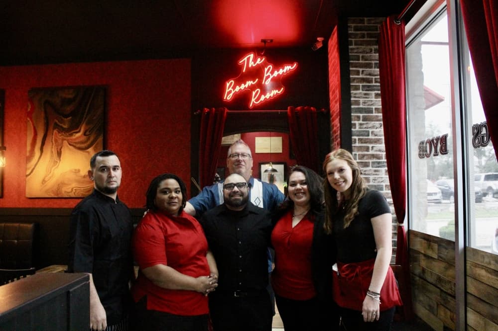 Bill Nychay and his staff standing inside The Red Door Kitchen 