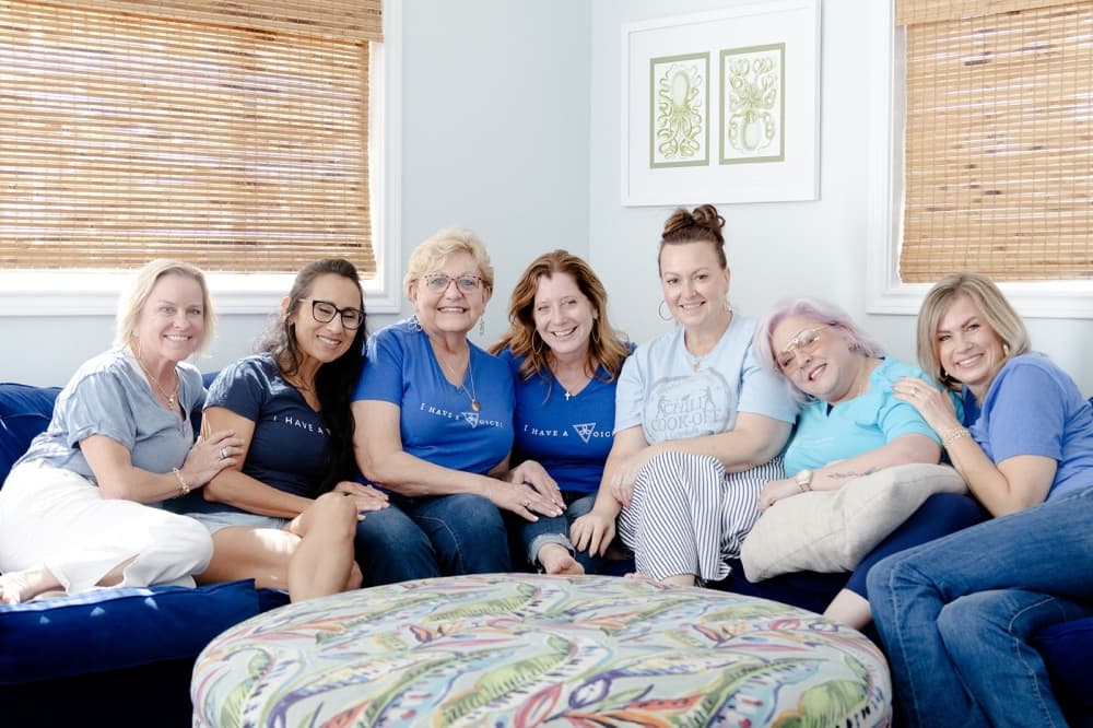 Hopeful Hearts Ministry leadership smiling on a sofa during a retreat.