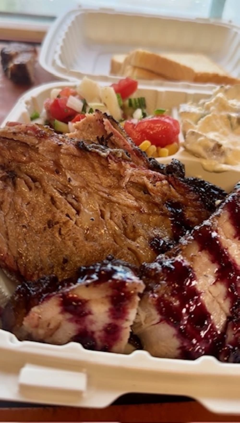 A plate of meat and sides is shown.