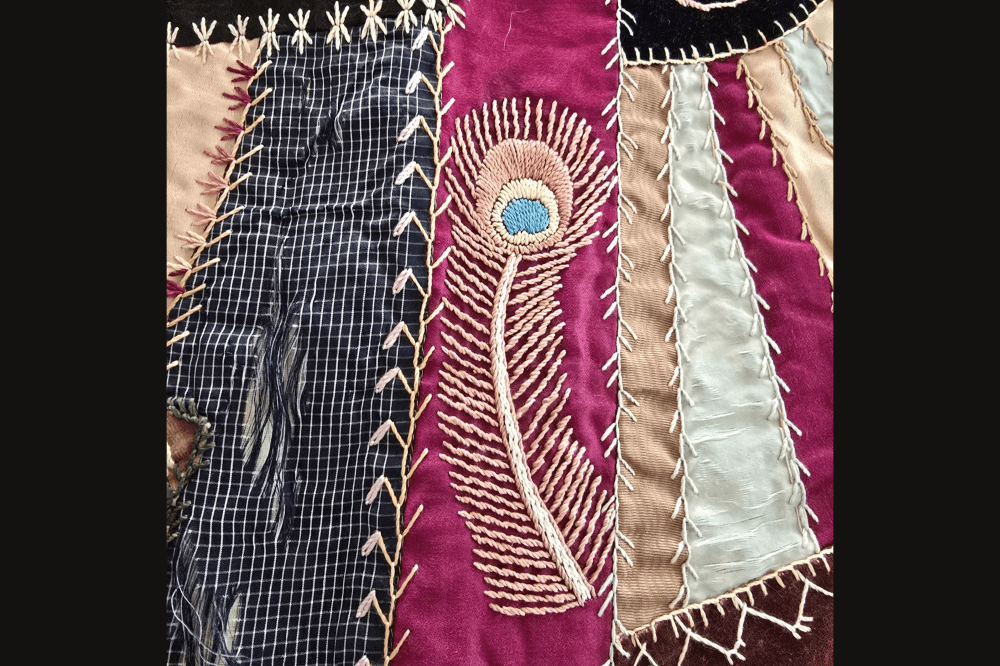 peacock feather on crazy quilt