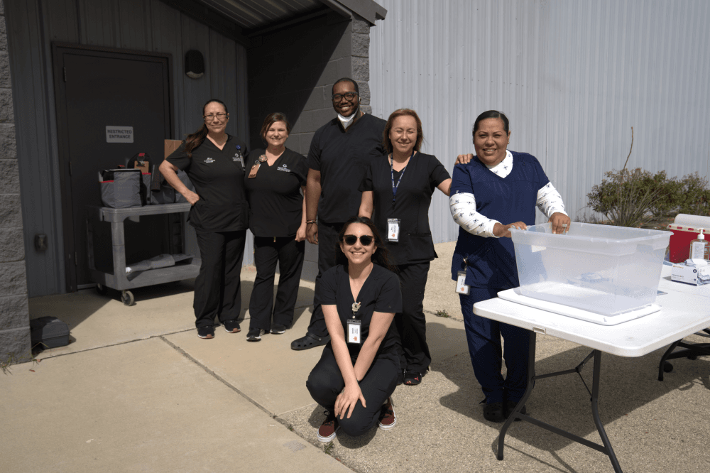 Volunteers and staff working together inside Serve Denton community center