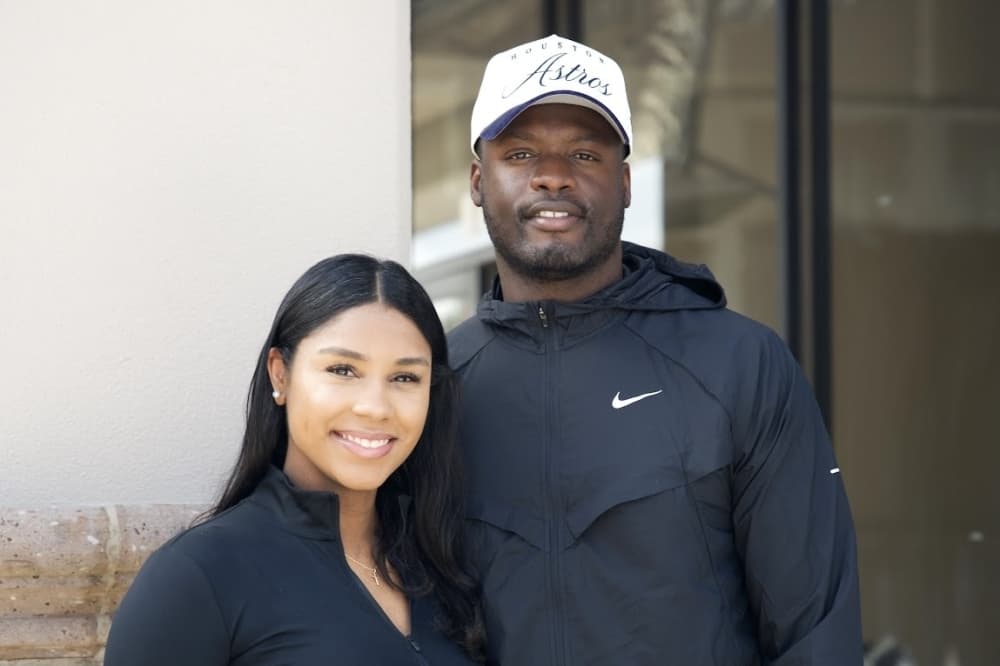 headshot of a couple in black nike clothing