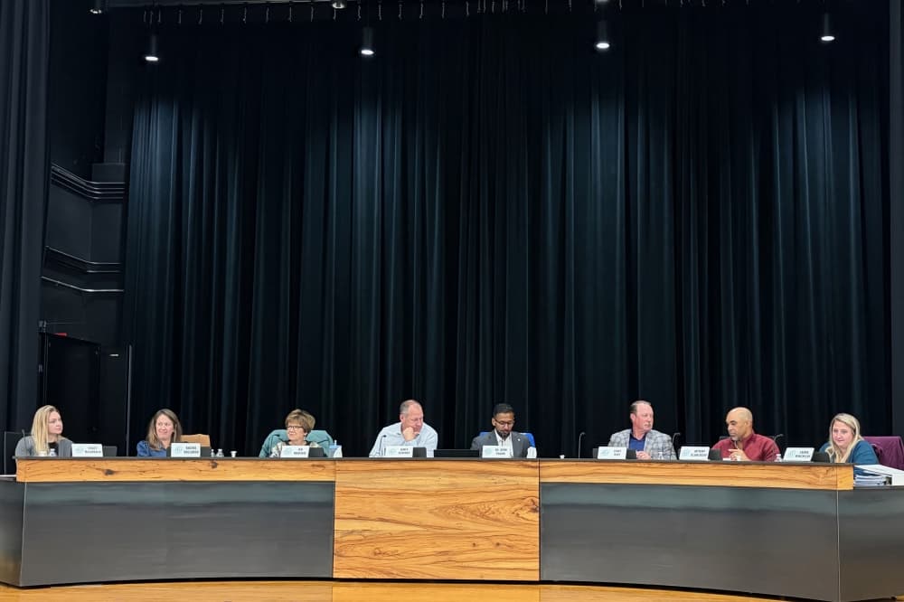 The Georgetown ISD board of trustees on a stage. 