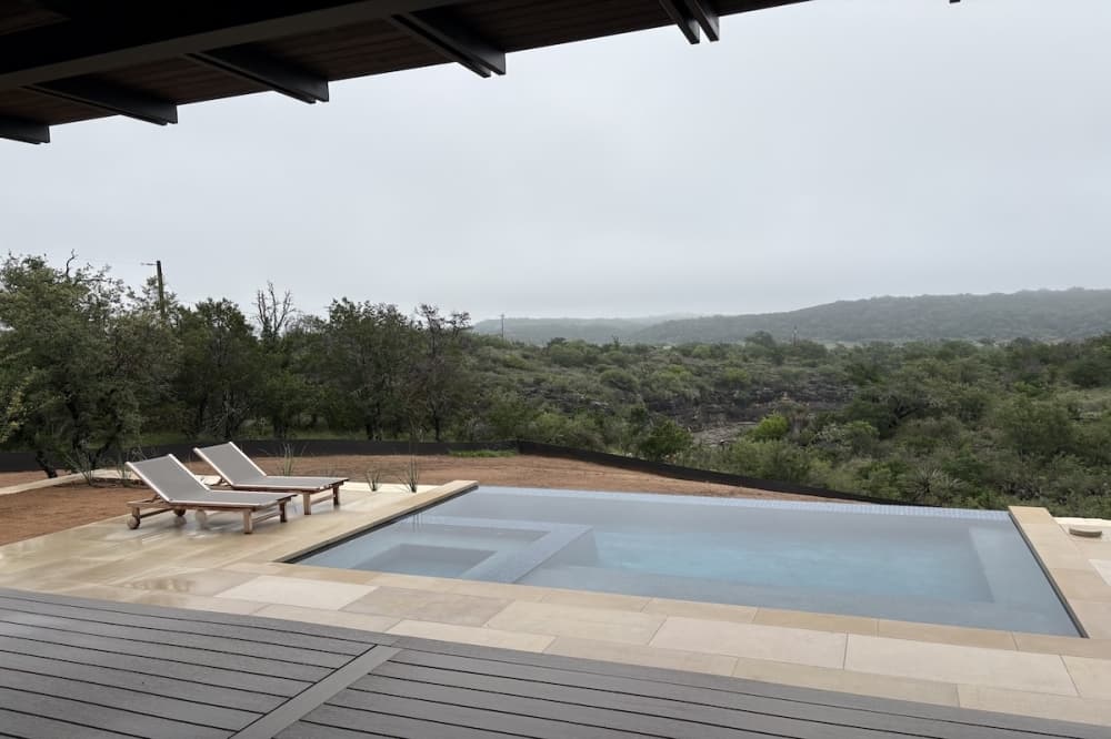 Back patio and pool overlooking Lake Travis at one of the 3D-printed homes at The Canyon Club in Spicewood.