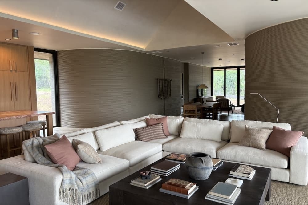 Living room space inside a 3D-printed home at The Canyon Club in Spicewood