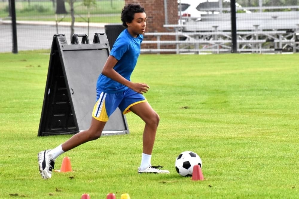 kid doing soccer drill 