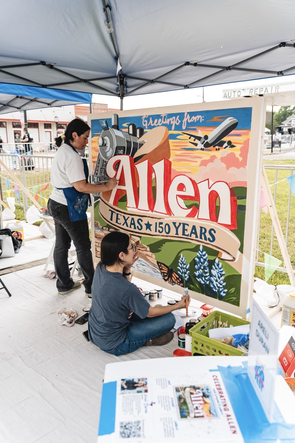 people painting a mural