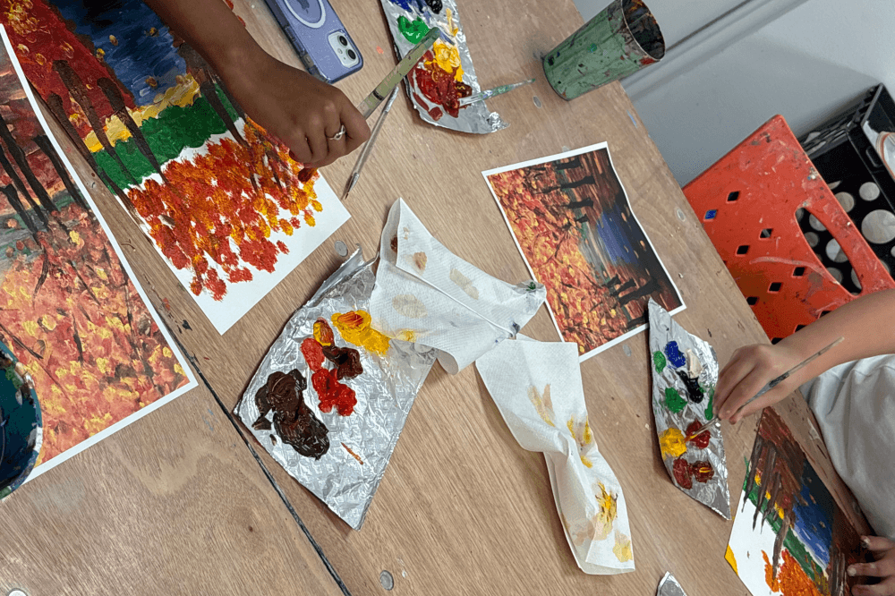 Close-up of child’s hands painting in art class at Katy Art School, part of youth art education program promoting creativity and artistic development in Katy Texas