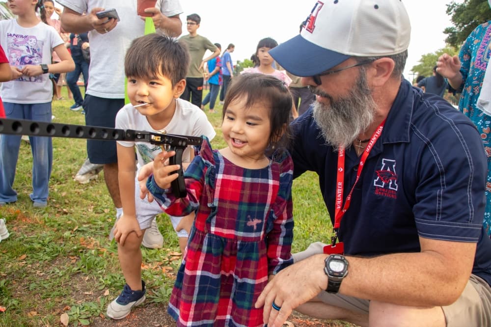 students smiling while doing an activity at allen isd's field day for everyone event