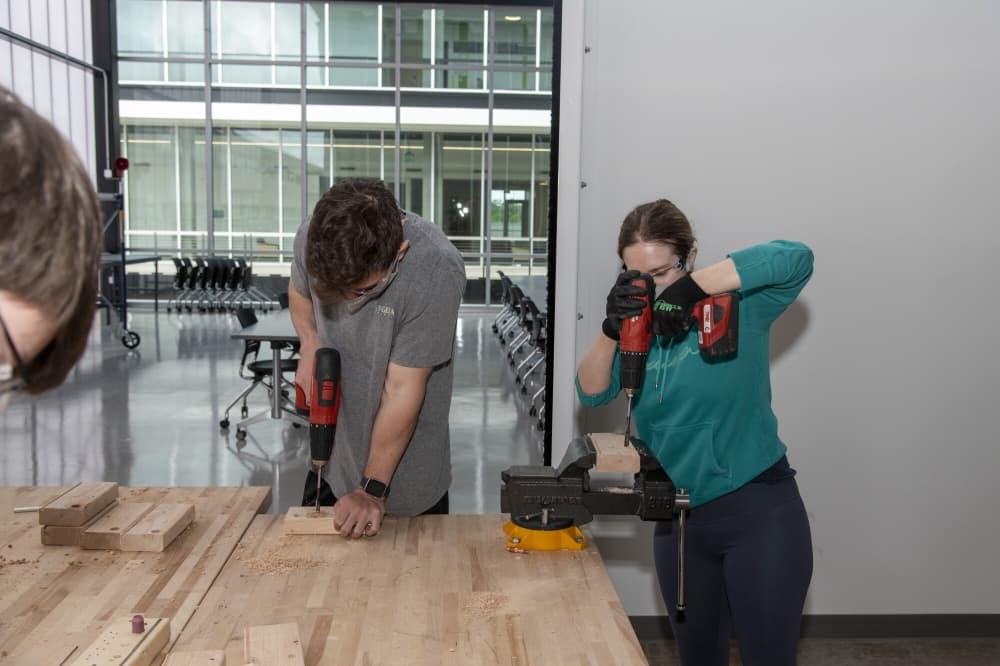 students drilling wood
