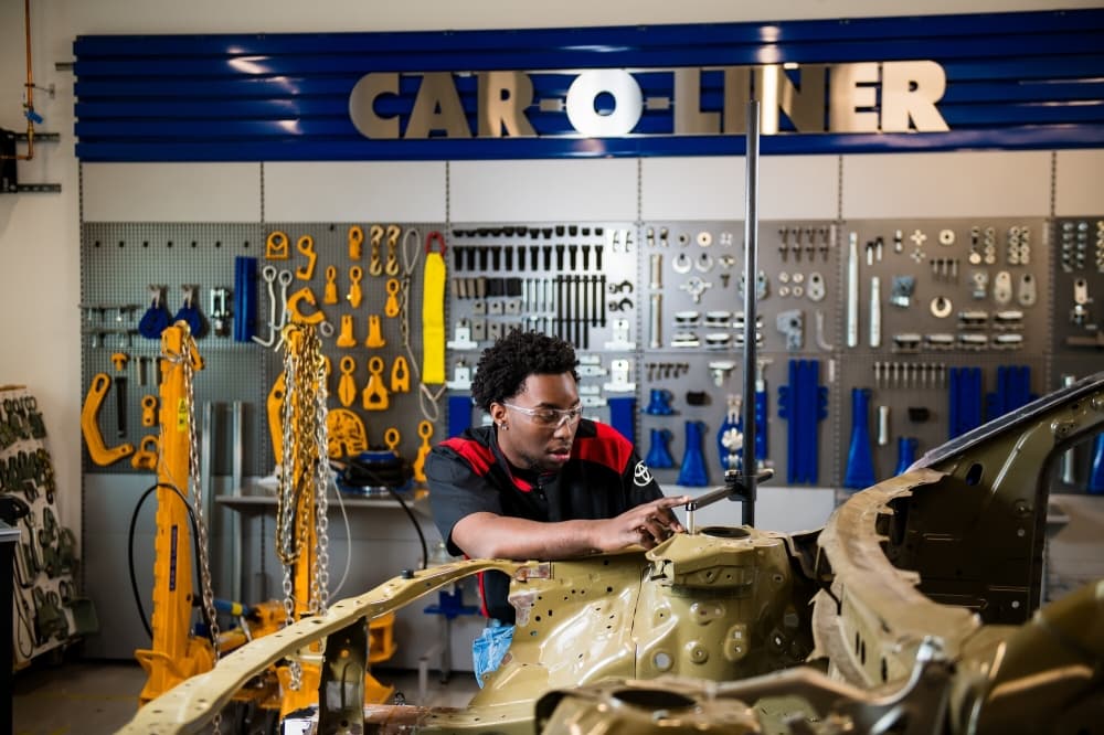 student working on a car