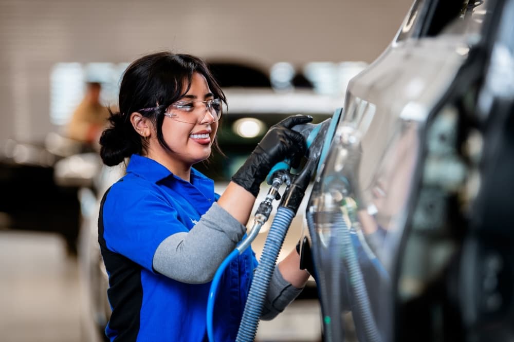 student working on a car