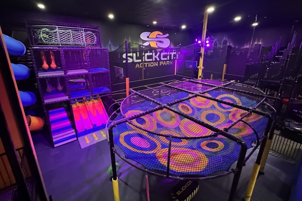 The action park has an air track basketball and dodgeball courts, which are courts that have a padded flooring that also lets players bounce, and a web crawler. (Heather McCullough/Community Impact)