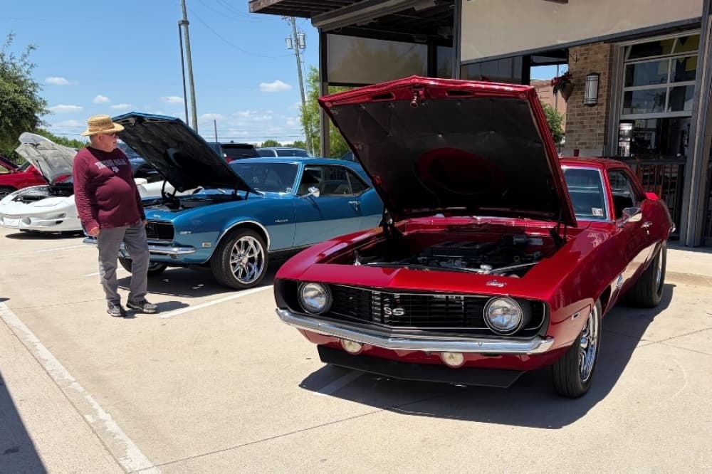 man looking at cars