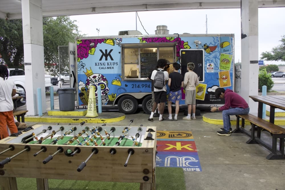 a food truck with games and picnic tables