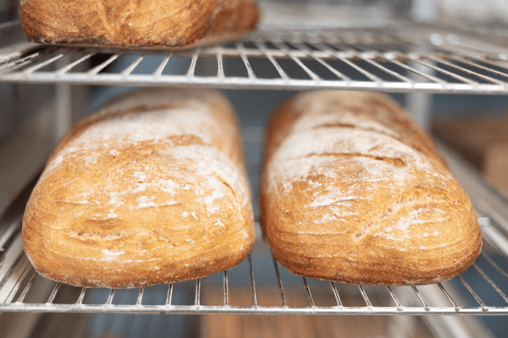 Fresh artisan bread and sourdough loaves baked from scratch at Blue Baker using a 25-year-old sourdough starter in College Station Texas