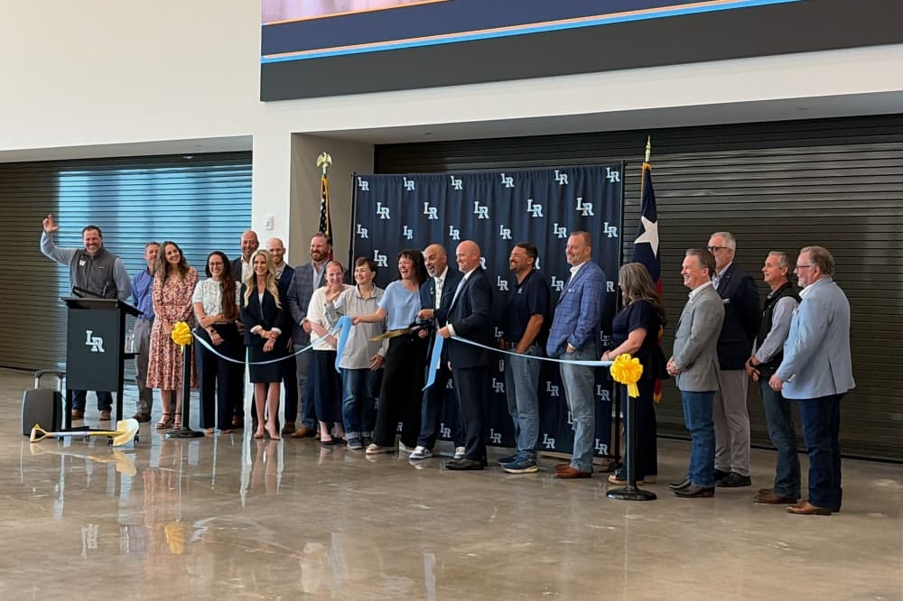 Liberty Hill ISD leaders and board of trustees cut a ribbon