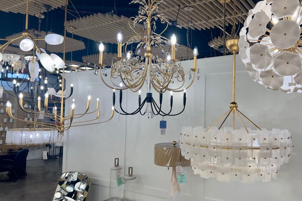Display of geometric in-wall LED channel lighting and recessed lighting options in a showroom.