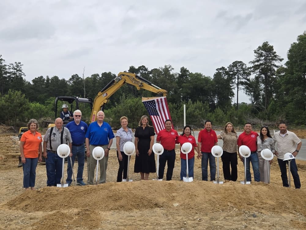 Owners of Pat's Donuts, representatives for Bazcon builders and officials with the East Montgomery County Improvement District holding shovels and hard hats on a construction site.